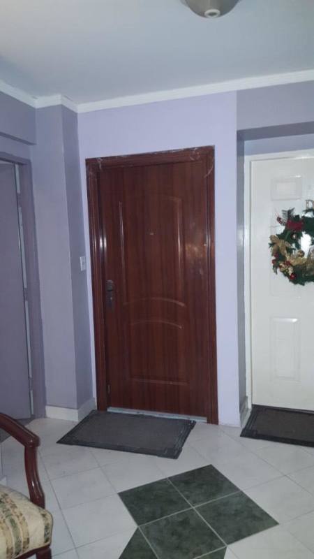 Entrance hall with wooden door and decor PH Park 66 apartment Obarrio Panama City