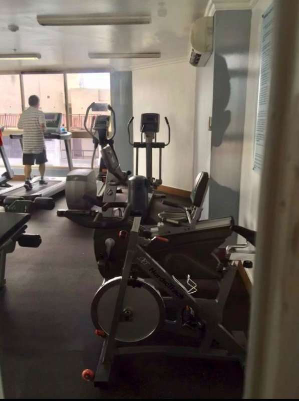 Kitchen with granite countertops, refrigerator, microwave and washer dryer in PH San Francisco Bay Panama