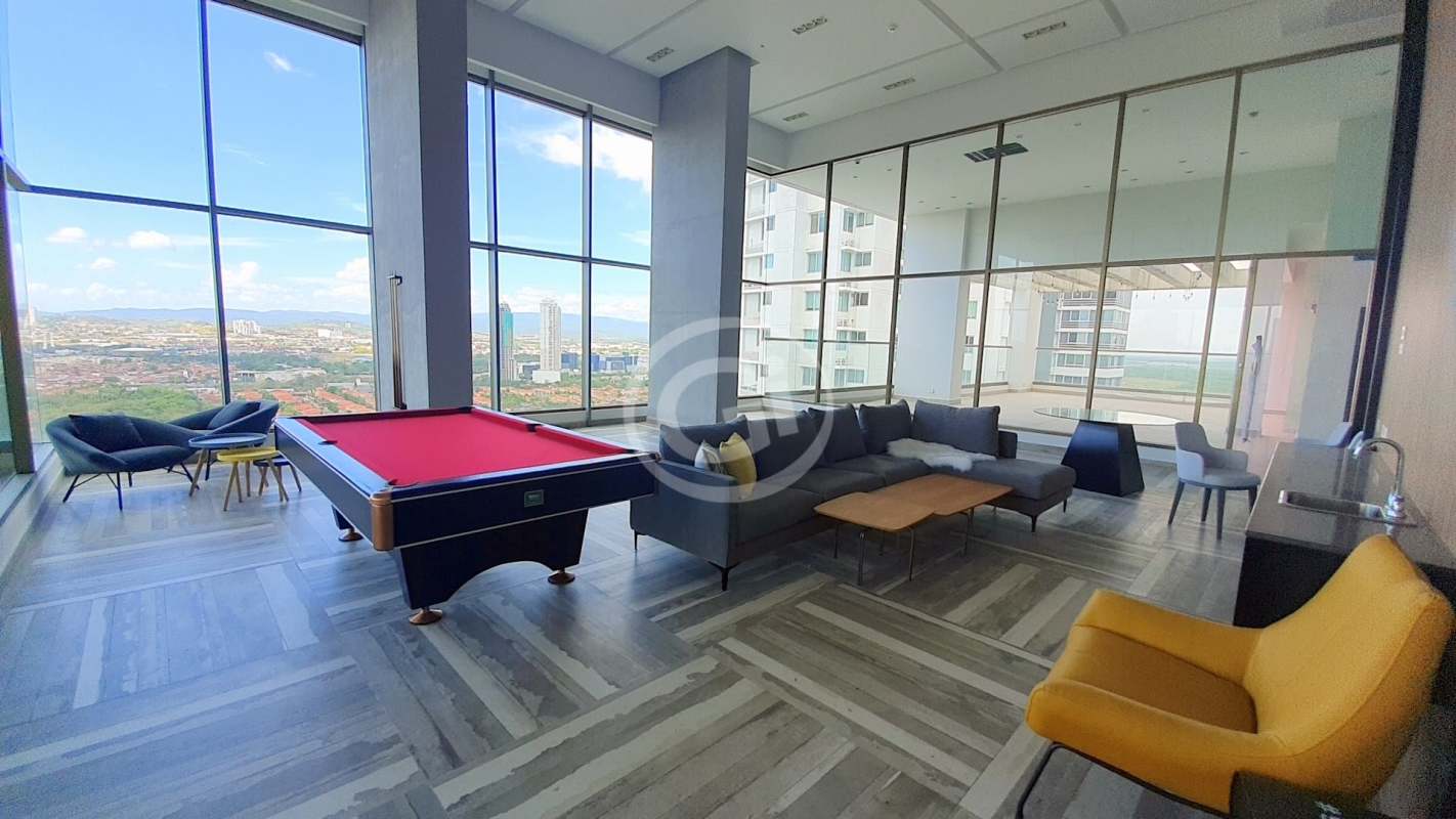 Infinity pool with glass railing overlooking Panama City skyline and ocean at PH Park View tower