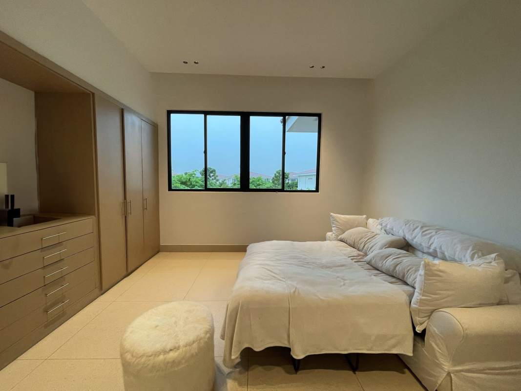 Covered terrace with BBQ-ready area tiled floor and garden at The Grove luxury house Panama