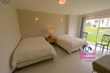 Spacious open living and dining room with vaulted ceilings, large glass doors, and natural light in Costa Blanca Golf Villas Panama