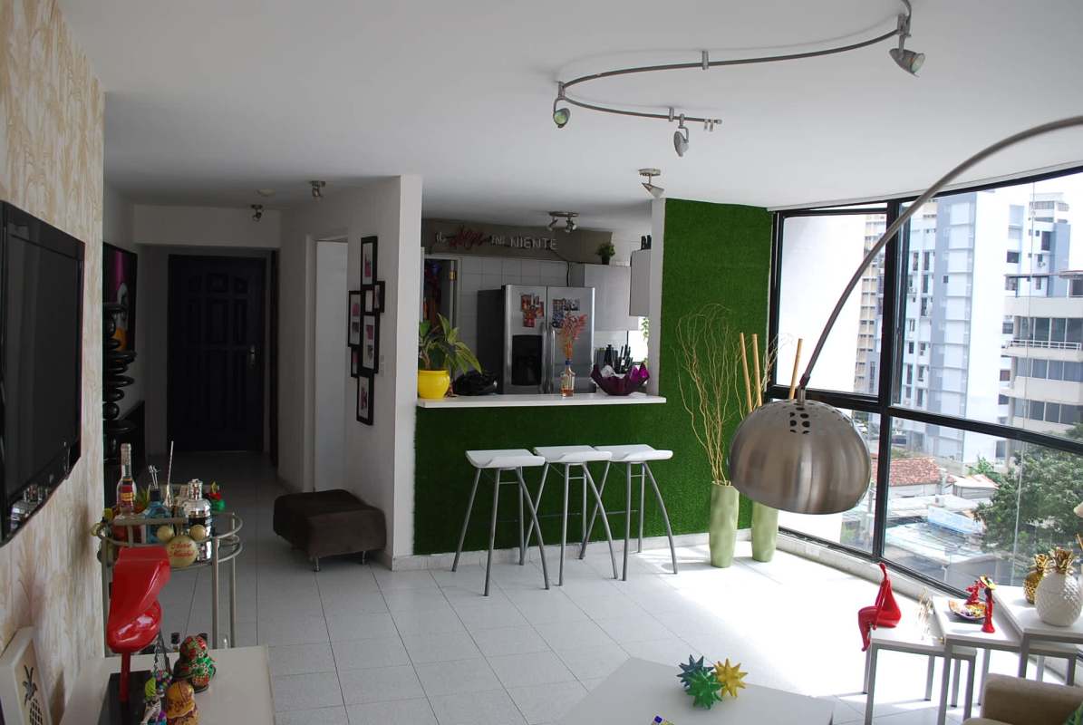 Living room and dining with large windows, city skyline views Panama apartment for sale