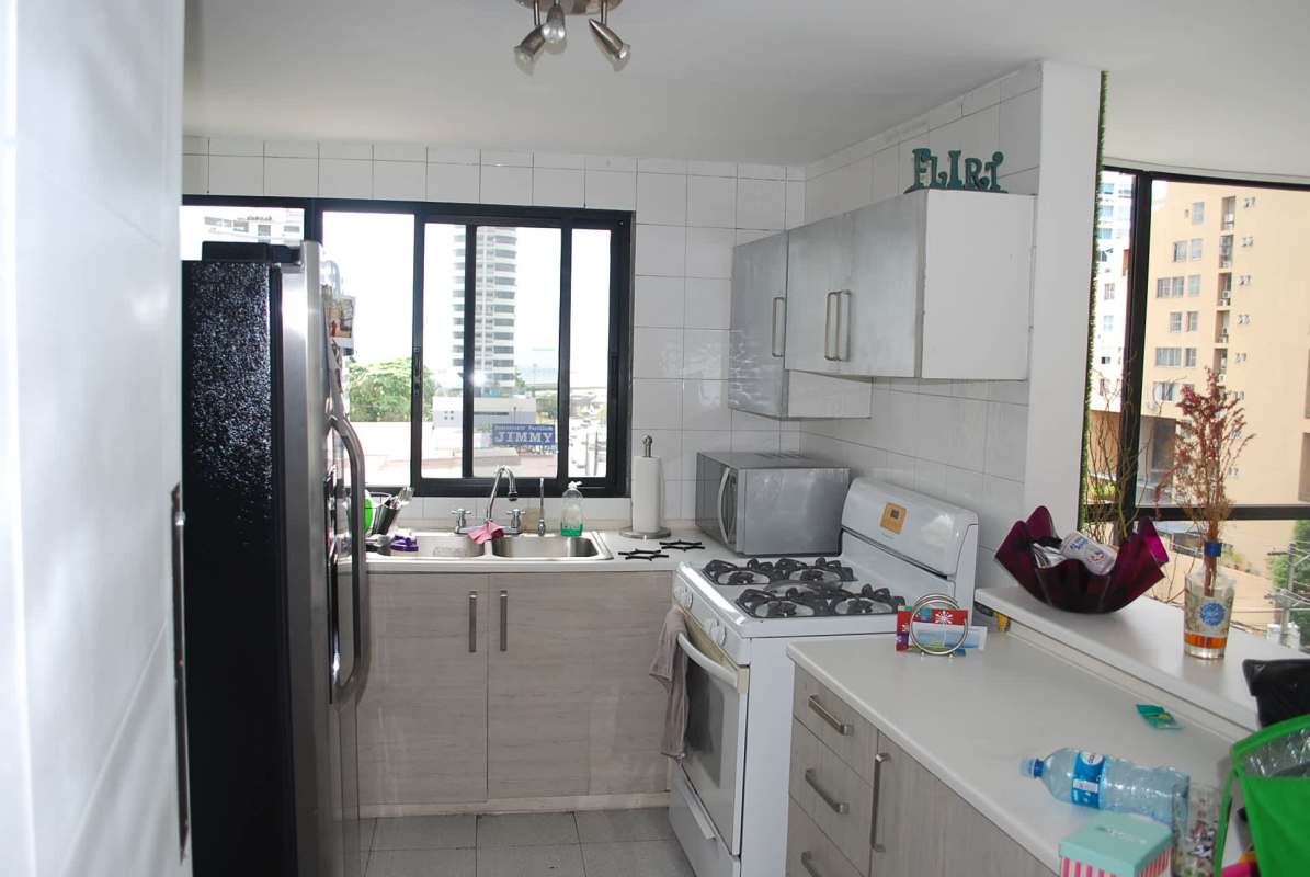 Contemporary living room with balcony doors, AC, wallpaper and city views in Panama City apartment