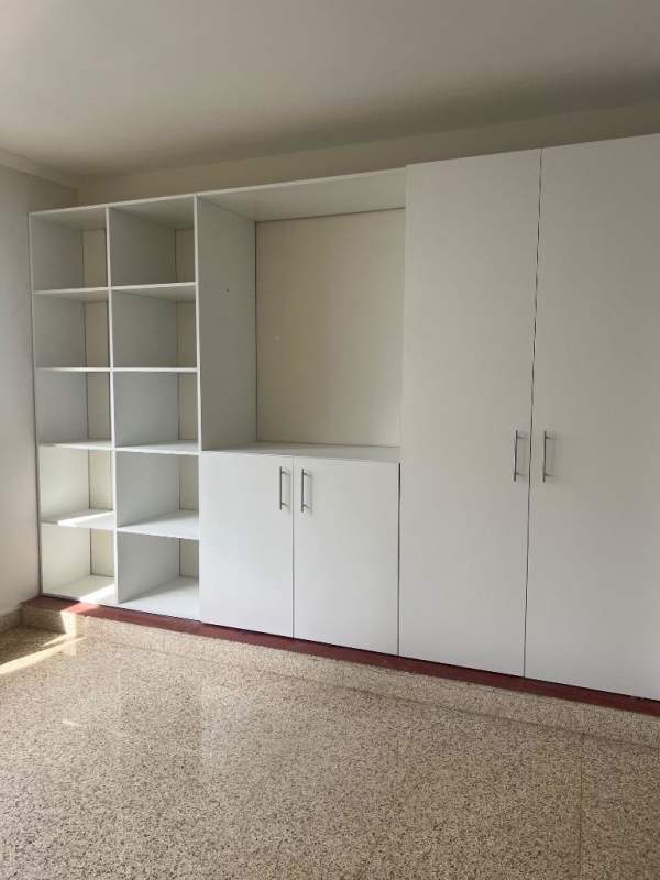 Empty bedroom space with large window, wood-style flooring and city view in PH El Cangrejo Panama City