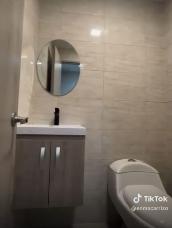 Compact bathroom in medical suite, beige tile walls, vanity sink, toilet at Town Center Costa del Este Panama