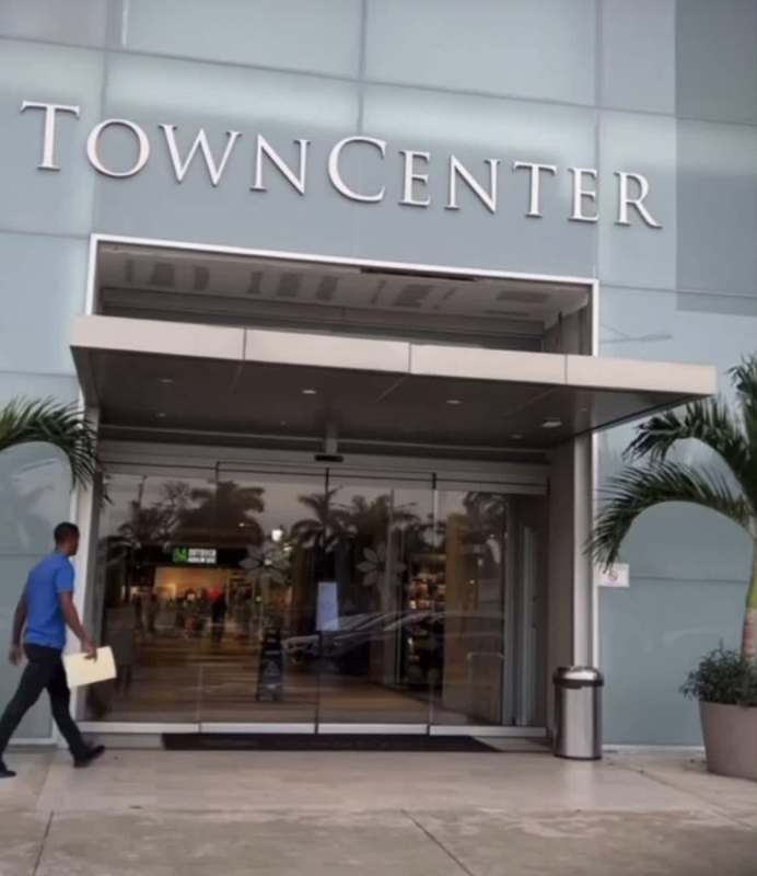 Main lobby of Town Center Costa del Este with glass entrance and potted palms, Panama