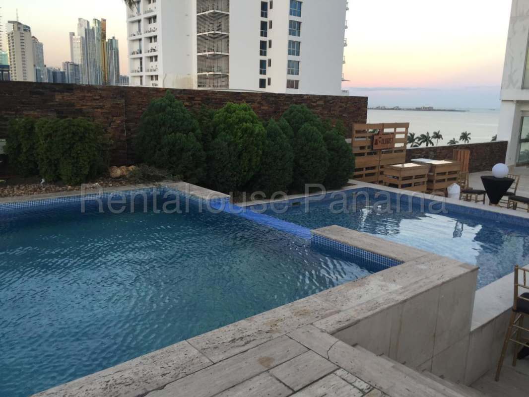 Modern infinity swimming pool with ocean skyline view at PH BICSA Avenida Balboa Panama City