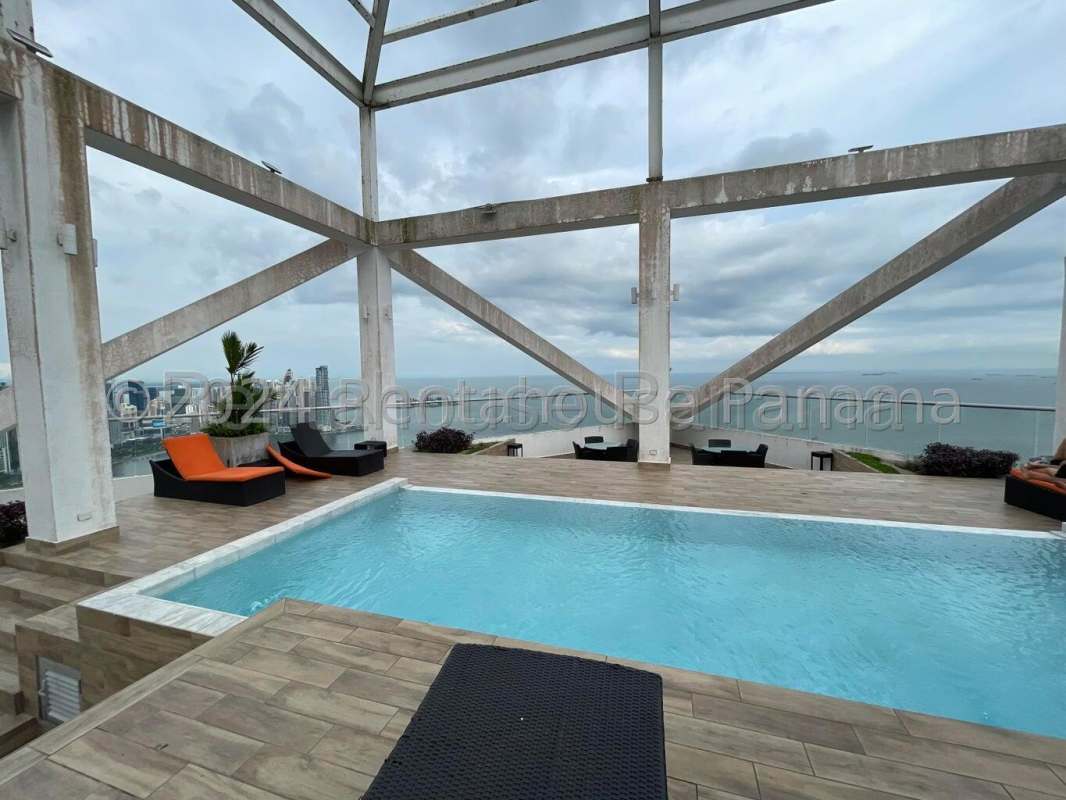 Rooftop pool area with panoramic ocean and city skyline view at PH BICSA Financial Center Panama