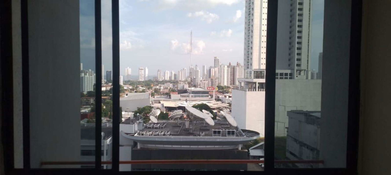 Urban Panama City skyline through glass window PH Torres del Sol