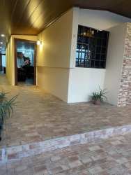 Bedroom with lavender walls, mirror closet, tiled floor in Colón house for sale Panama