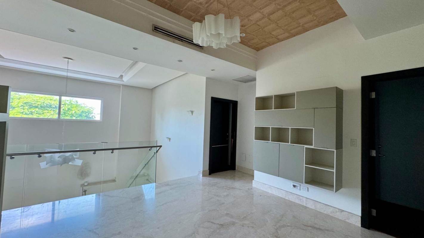 Modern staircase with glass railing and chandelier in PH Toscana del Este luxury house Panama