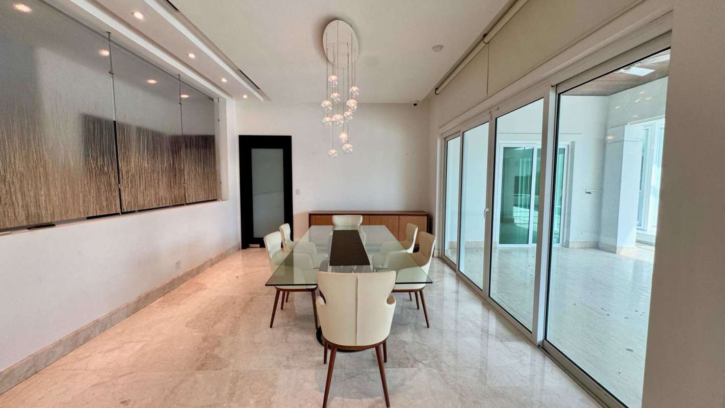 Bright living room with marble floors, large glass sliding doors, garden and pool view Costa del Este