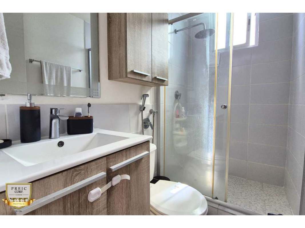 Bathroom with glass-enclosed shower, vanity sink, and gray tile in PH Solok Parque Lefevre Panama City