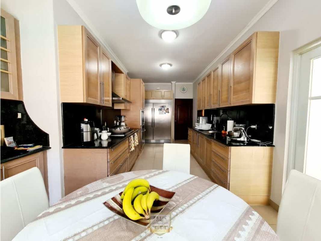 Wood kitchen with granite countertops and stainless steel appliances Costa del Este Panama