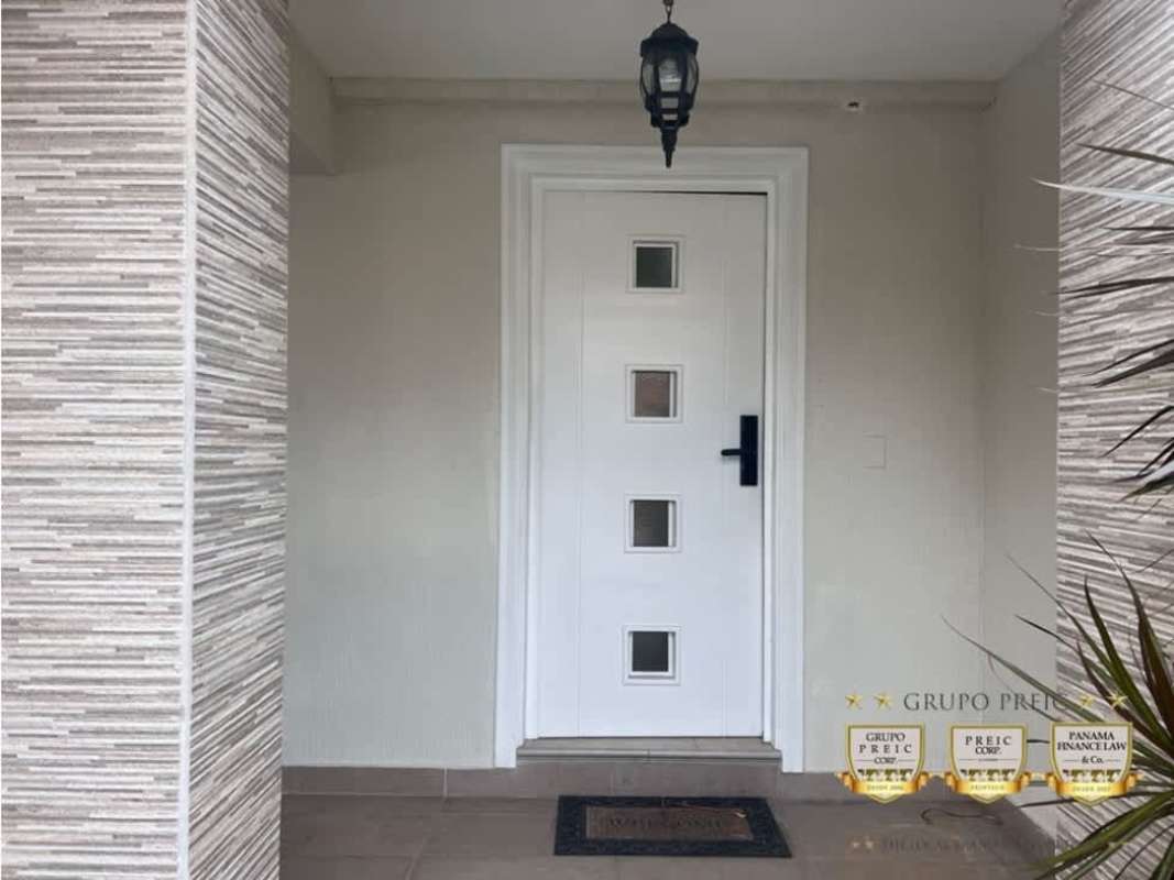 Spacious foyer with backlit mirror, floating console, staircase in remodel house Reserva Versalles Panama