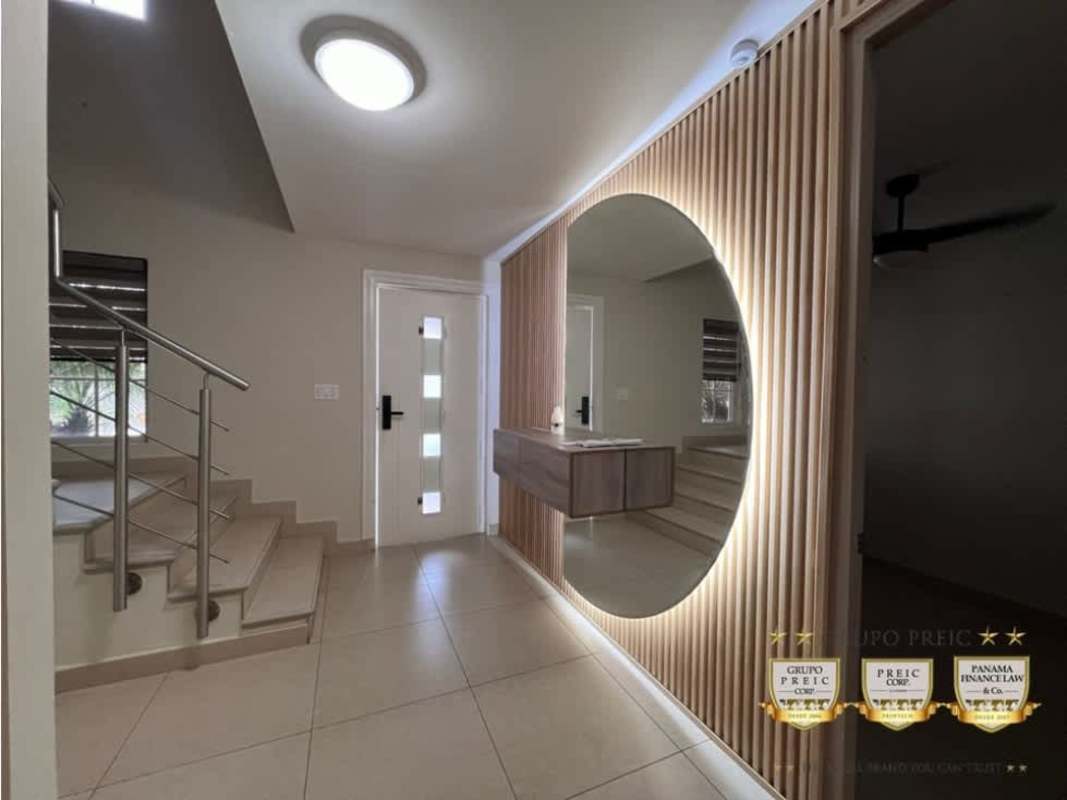 Kitchen with granite counters, light wood cabinets, black backsplash, oven range in remodel house Don Bosco Panama City