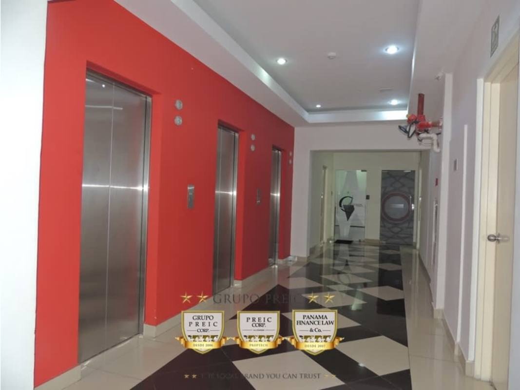 Modern elevator lobby with stainless elevators and red accent wall in PH Brazil 405 Via Brasil Panama City