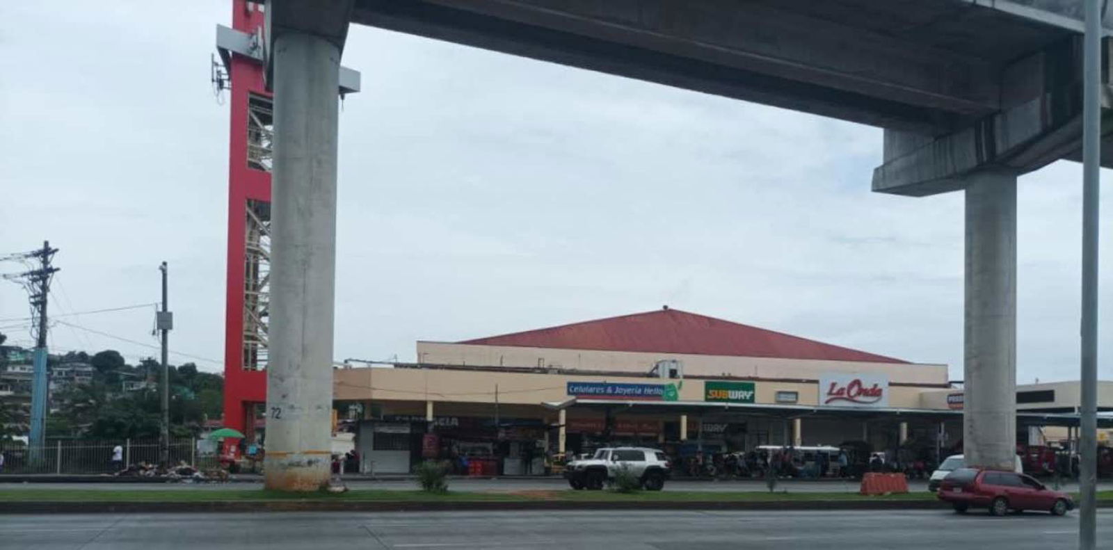 View of commercial shopping center façade and elevated track in Pueblo Nuevo Panama City