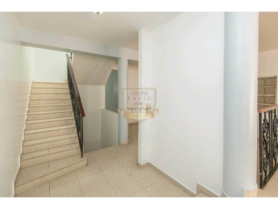Spacious bedroom with tile floor, large window, tray ceiling details at Villa de las Fuentes house Panama