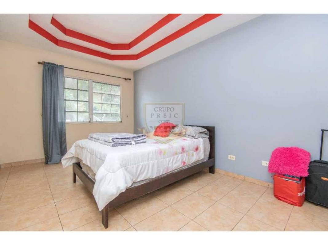 Tiled stairwell with neutral walls and metal handrail in spacious Villa de las Fuentes house Panama