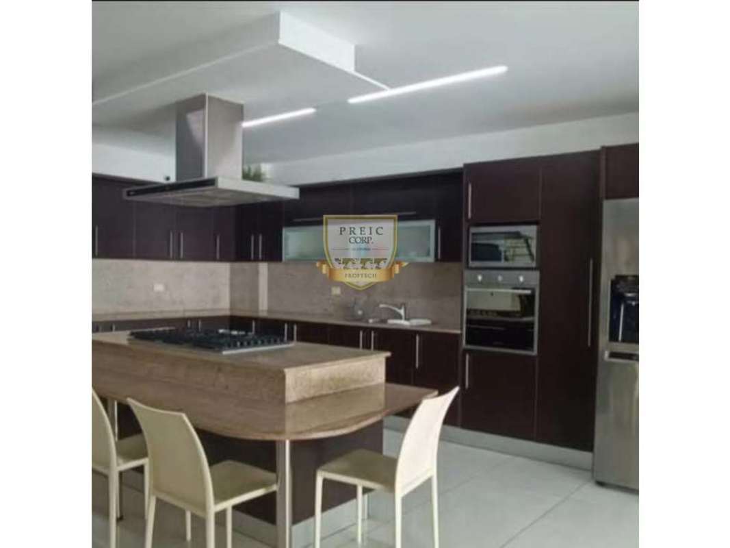 Spacious kitchen island with dark wood cabinets granite and stainless appliances Costa Sur Panama