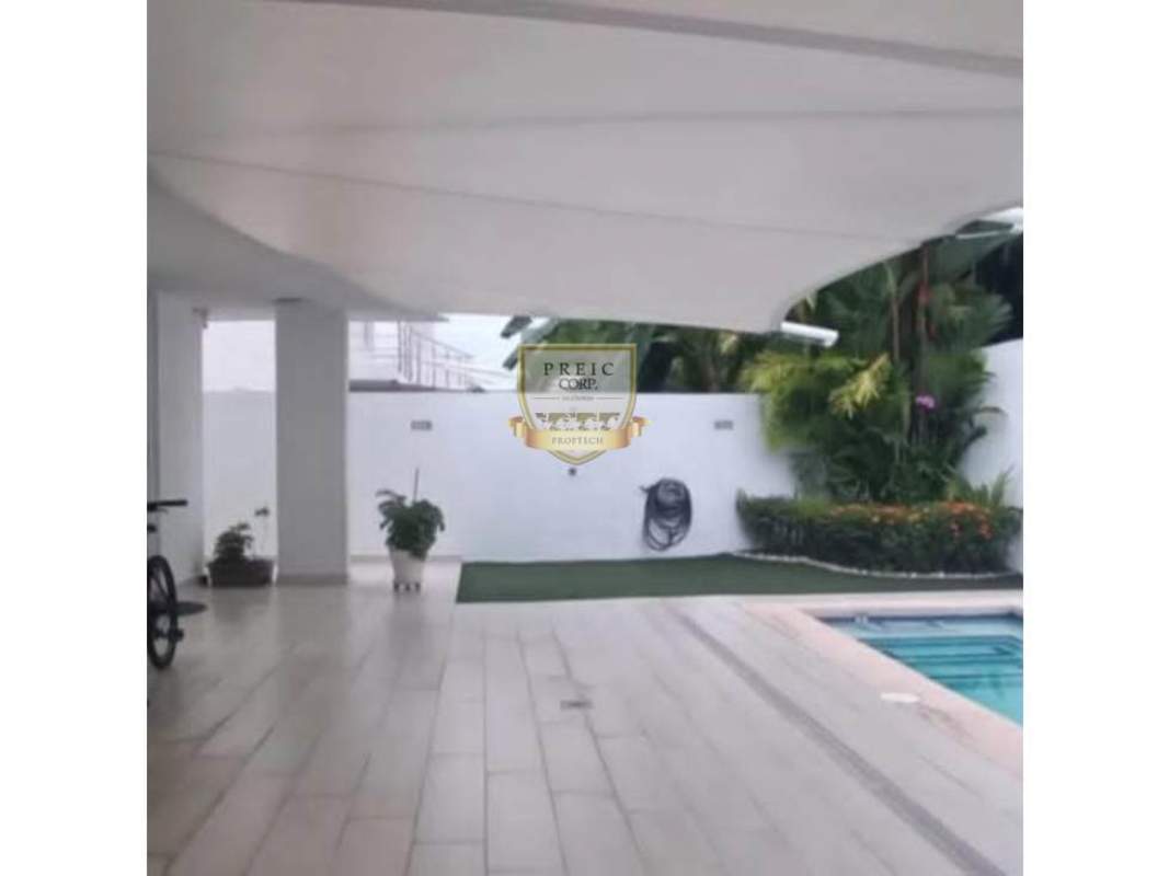 Modern living room with large windows, armchairs, glass table in Costa Sur Panama