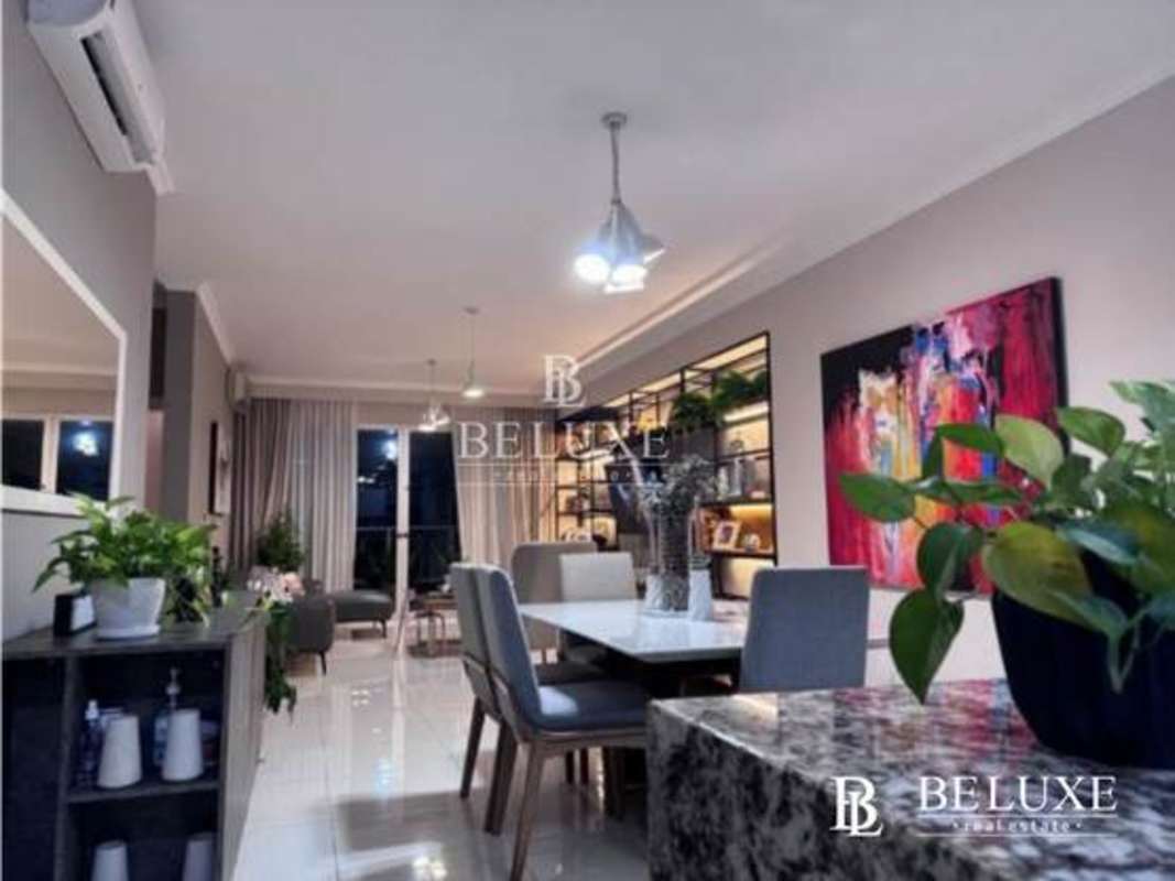 Bright open plan living and dining with pendant lights, wall art, large windows Nautica Tower Panama