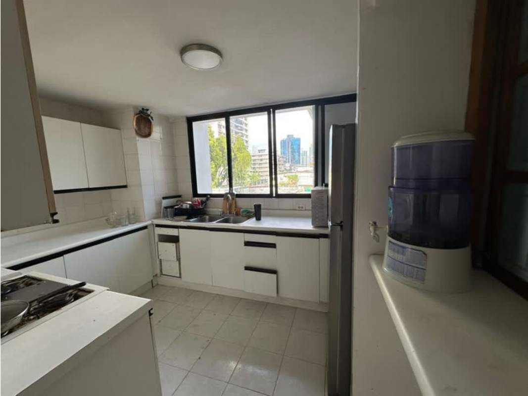 Kitchen with fridge, gas stove, white cabinets at PH Mirador, Obarrio Panama City