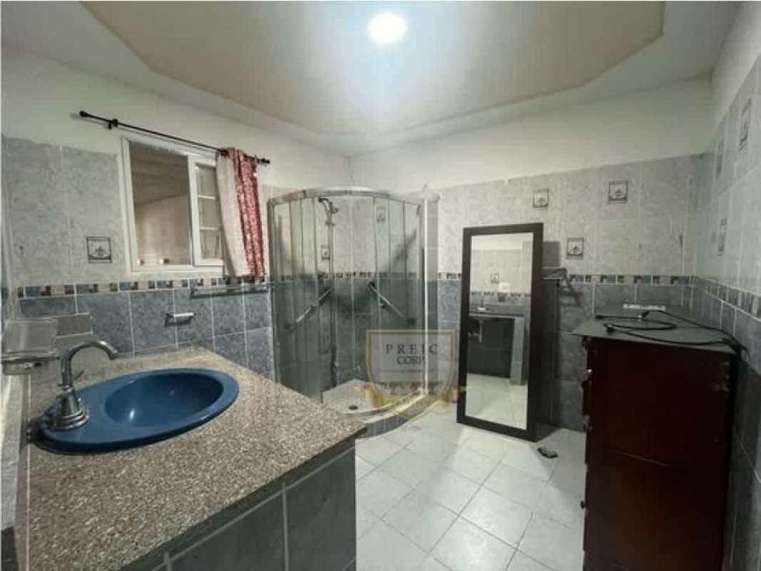 Modern bathroom with glass corner shower, granite top, blue-gray tile Panama house