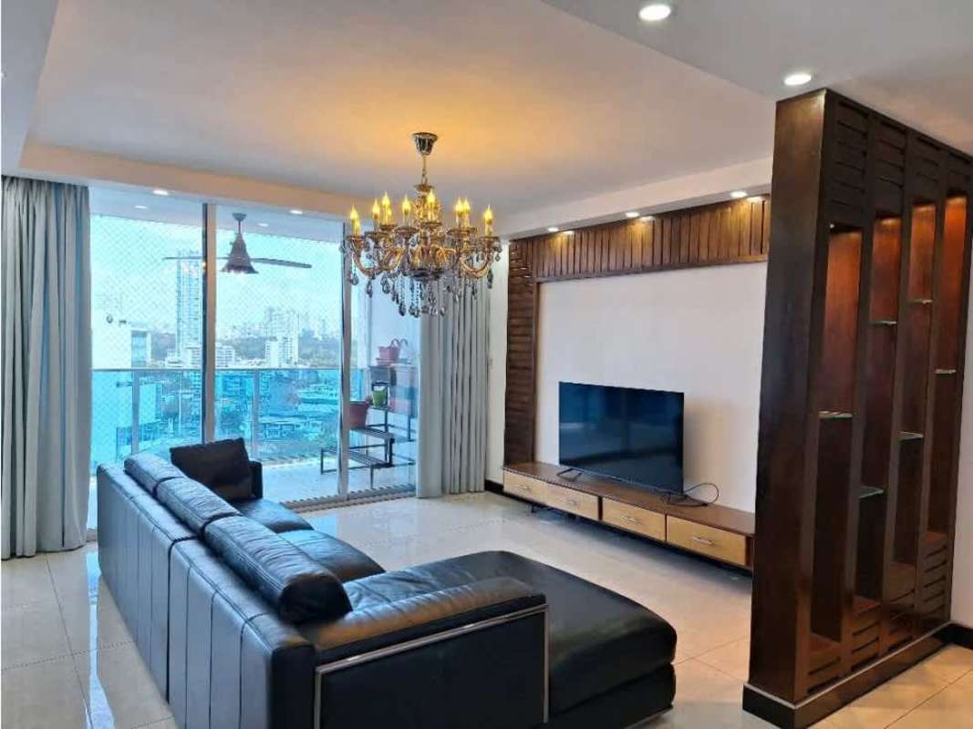 Spacious living room with large glass doors leading to balcony overlooking Panama City