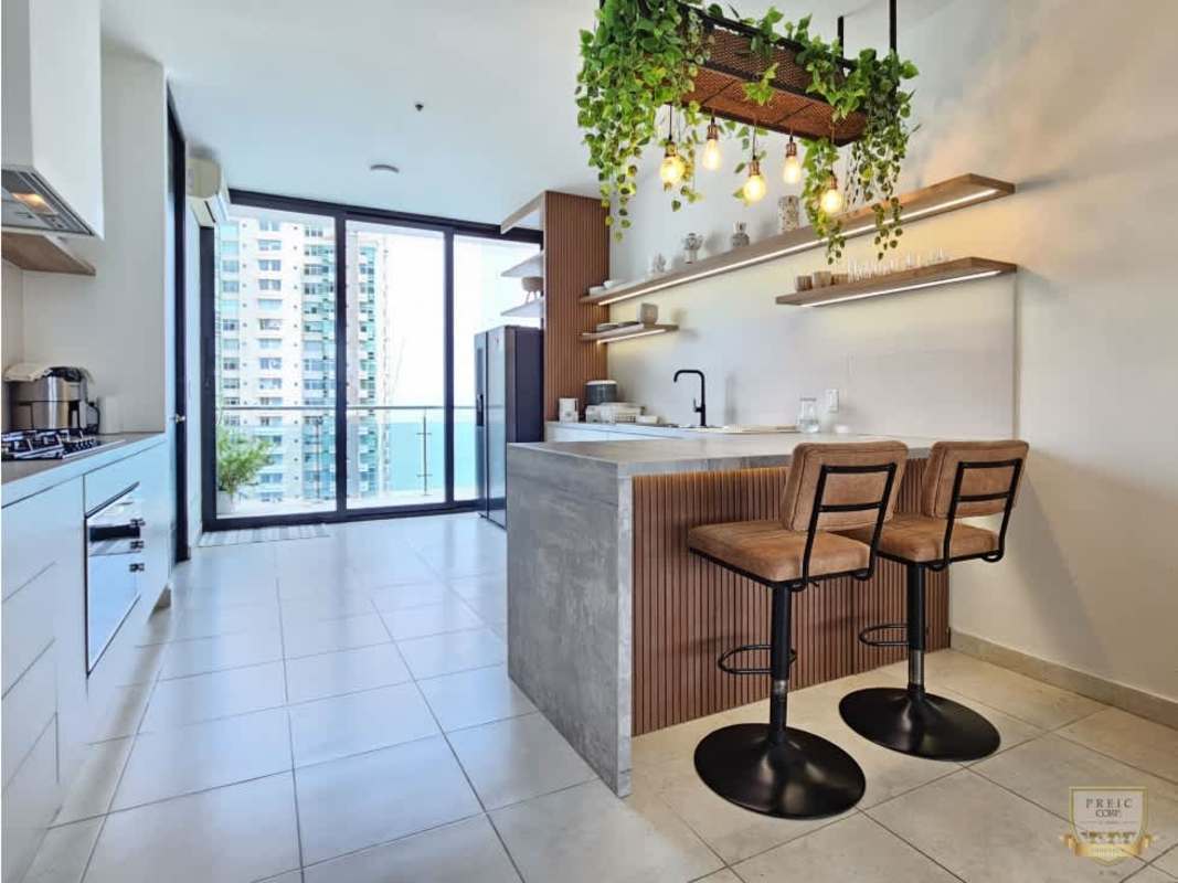 Gourmet open-plan kitchen with island bar, ocean view windows in luxury PH Aqualina Punta Pacífica Panama
