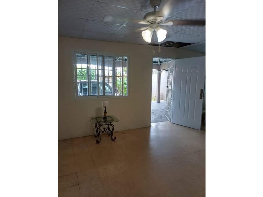 Living area with window security bars and ceiling fan Don Bosco house for sale Panama
