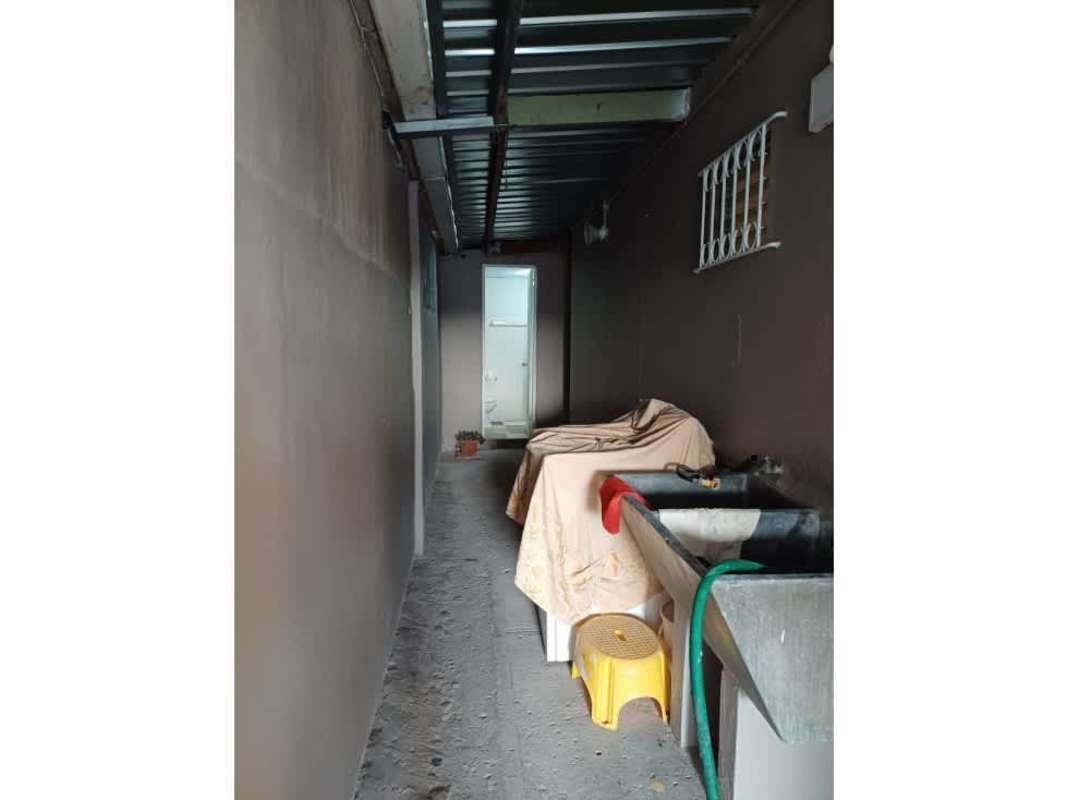 Utility corridor with concrete sink and laundry area Don Bosco house for sale Panama