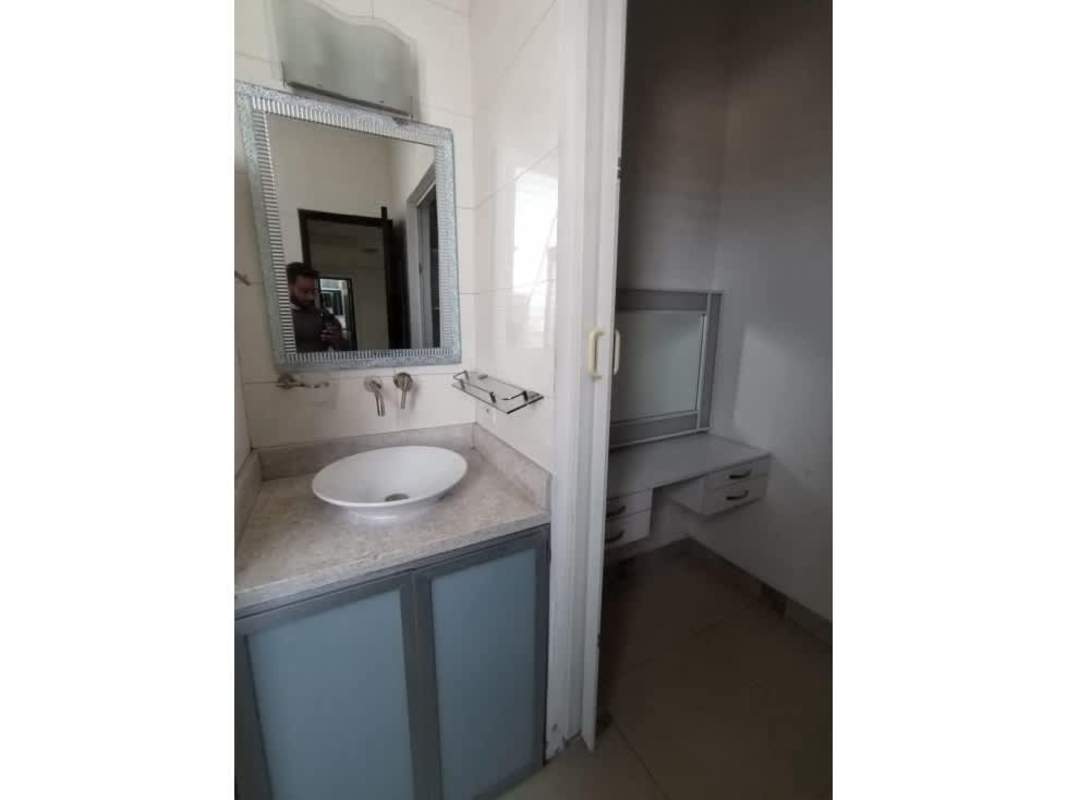 Bathroom with vessel sink, mirror, adjacent dressing area PH Calle 77 Panama City