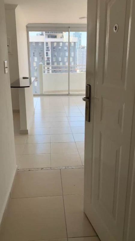 Bright living room with sliding glass doors to balcony PH Montemar San Francisco Panama City