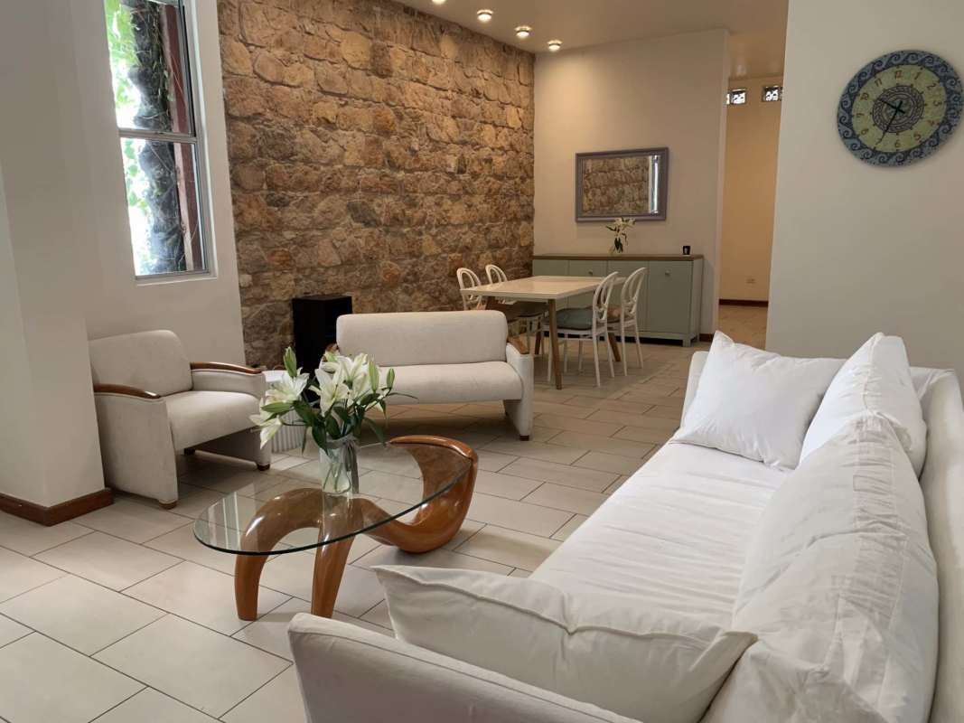 Spacious living dining area with calicanto stone wall in Casco Viejo apartment Star & Herald Panama