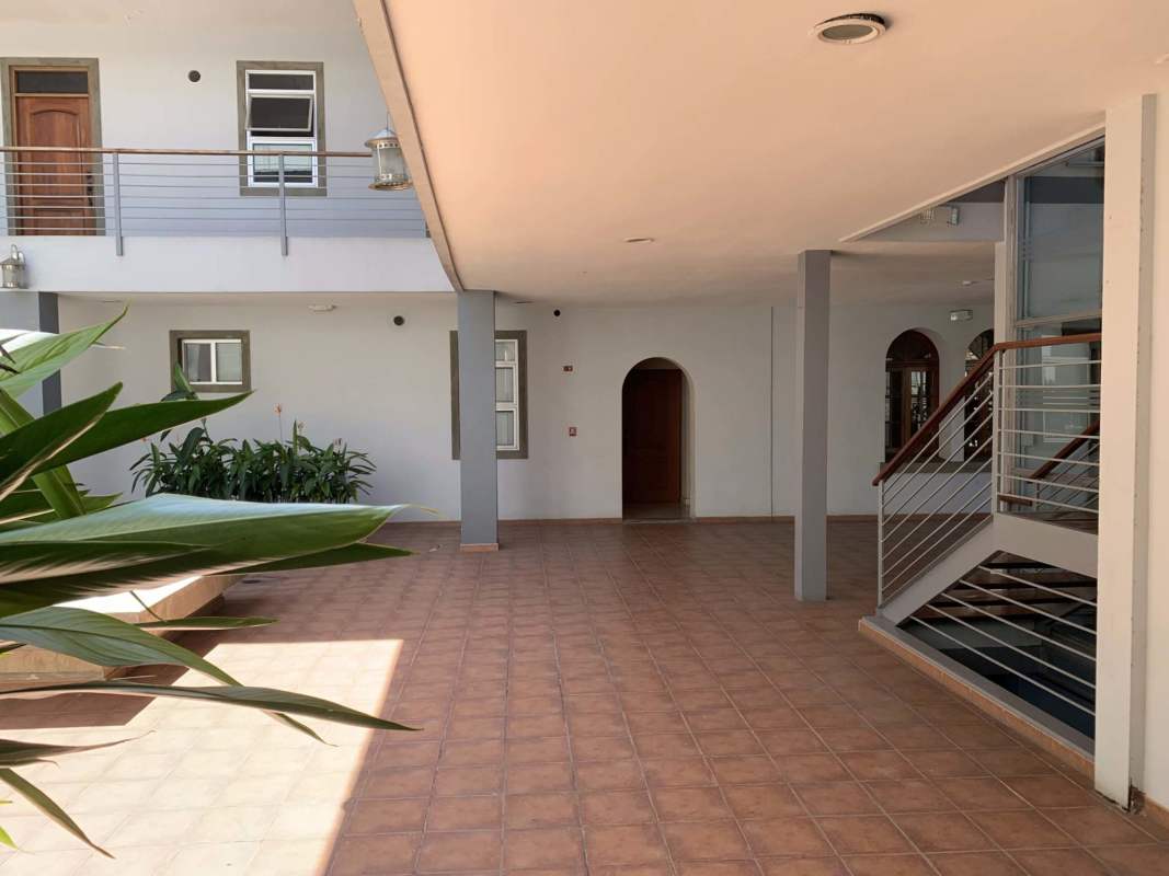 Open indoor courtyard with staircase and balconies at Star & Herald Residences Casco Viejo Panama
