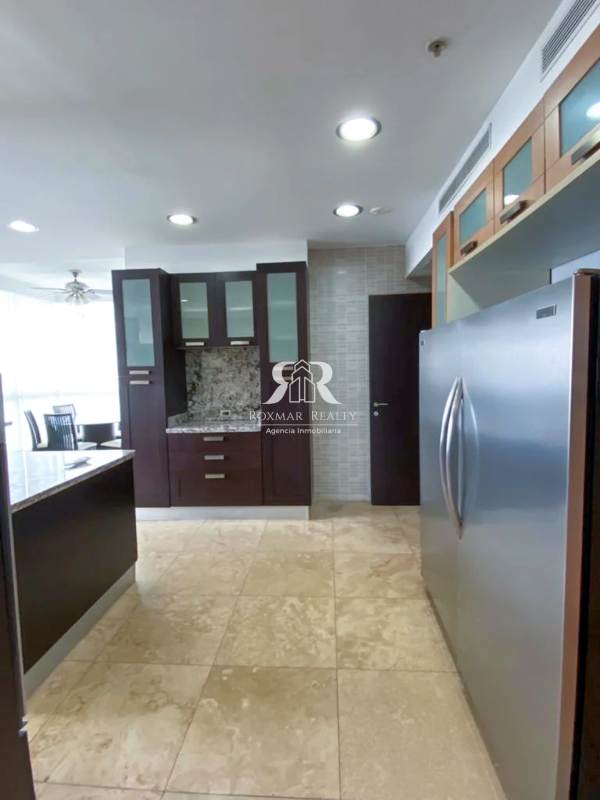 Large kitchen with granite counters, stainless appliances, and skyline view at PH Puntarenas Coco del Mar Panama