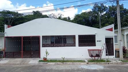 Enclosed balcony area with decorative grilles and wood-look tile flooring La Chorrera Panama house