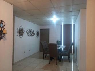 Narrow secure walkway with gate and small grass area in house La Chorrera Panama