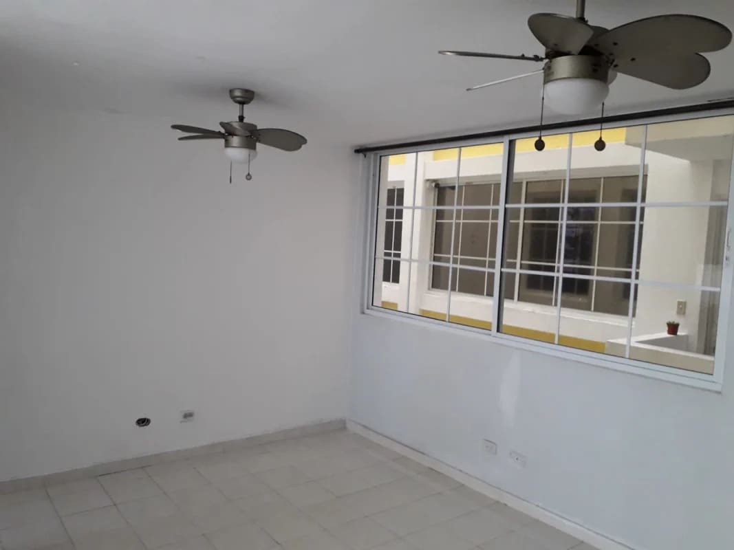 Modern living room with large window, ceramic tile and ceiling fans at PH Mystic Hill Panama