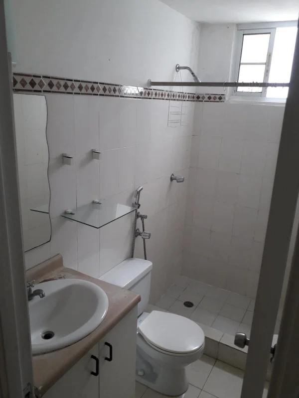 Compact bathroom with tiled walk-in shower and vanity at PH Mystic Hill Panama City