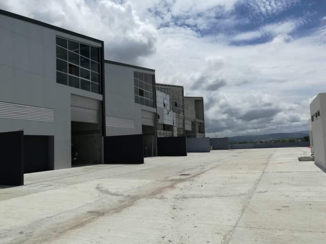 Modern industrial complex facade with large roller doors at Ofibodega Milla 8 Panama