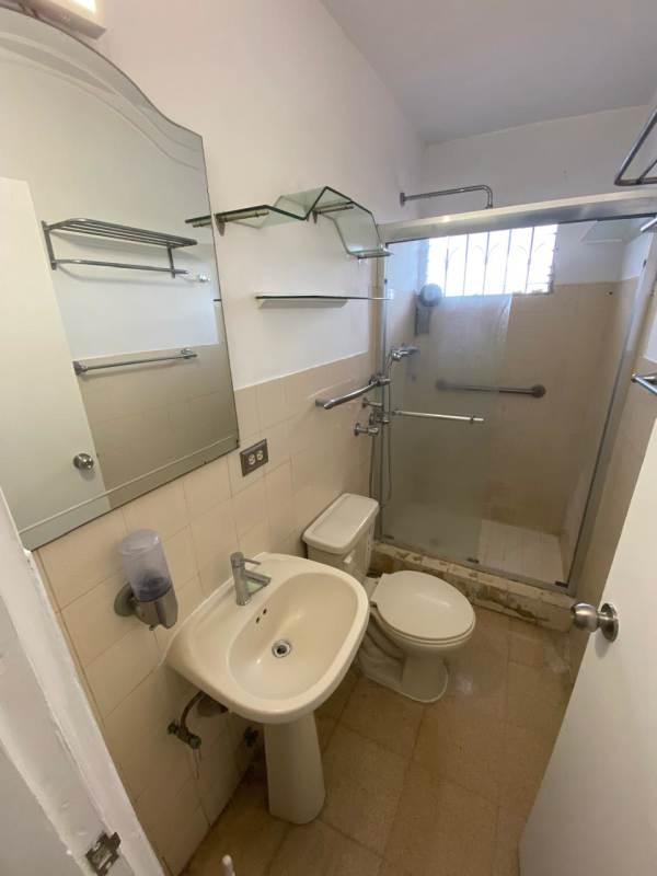 Bathroom with glass enclosed shower pedestal sink in PH Parque Lefevre Panama