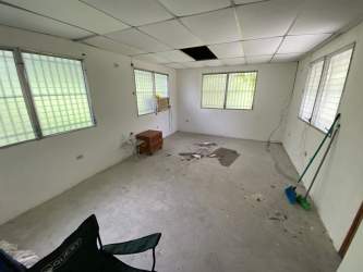 Unfinished interior room with barred windows at Panama beach cabin Costa Esmeralda
