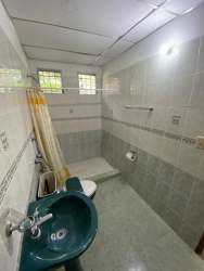 View of small house with covered porch and green lawn at Costa Esmeralda Panama