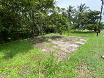 Vacant flat lot with foundation slab surrounded by greenery in Costa Esmeralda San Carlos Panama