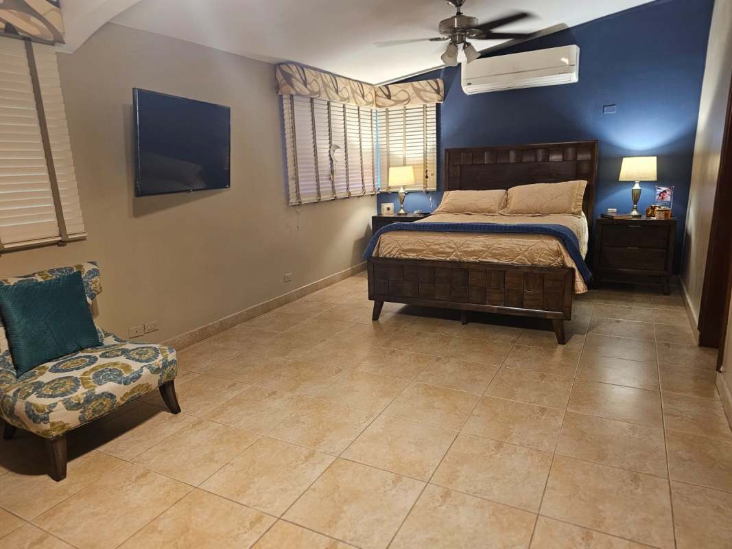 Bathroom with ceramic tiles, walk-in shower, granite countertop sink in Limajo home Panama