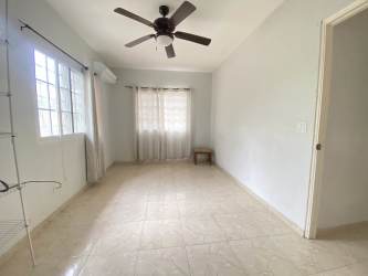 Large empty living area with tiled floors ceiling fans in country house near Gorgona beaches Panama