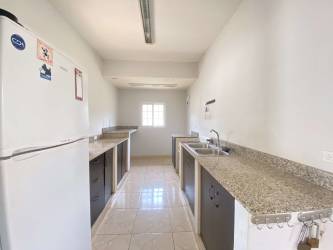 Galley kitchen with granite counters double sink in Sajalices Gated Community Panama